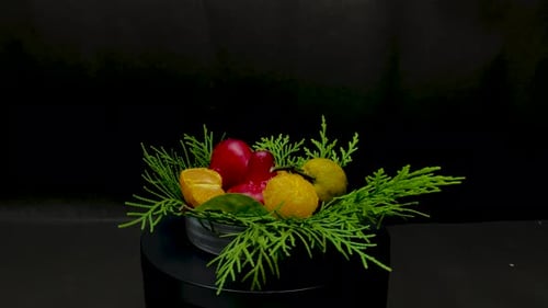 Rotating Bowl of Fresh Fruit with Greenery