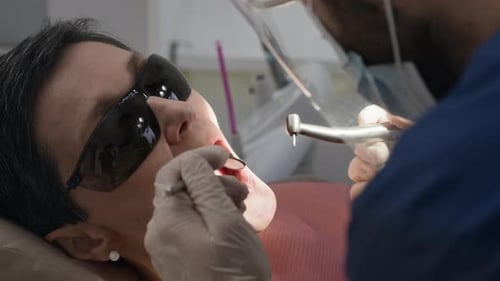 Dentist Conducting Oral Examination on Patient Using Sterile Dental Tools