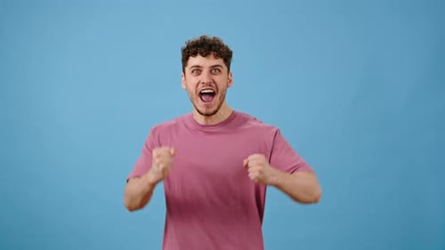 Ecstatic Man Celebrating Victory on Blue Background