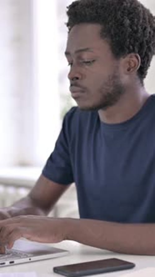 Sick African Man Coughing in Modern Office, vertical video