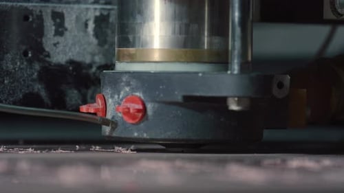 Industrial milling machine carving metal detail in manufacturing plant