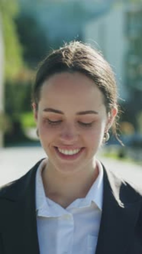 Smiling Woman Talking on Phone Outside in the City