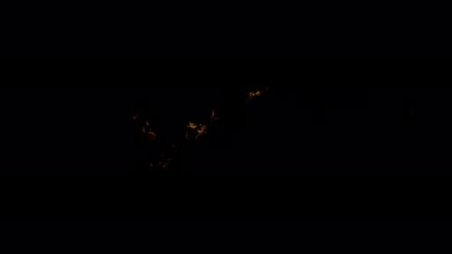 Ignite Collection: An ignited fabric swings in center on a dark background shot in 4k at 60fps