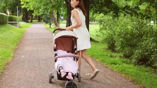 Family, Motherhood and People Concept - Happy Mother with Baby Girl Sleeping