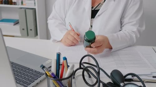Doctor Working at Desk with Medicine