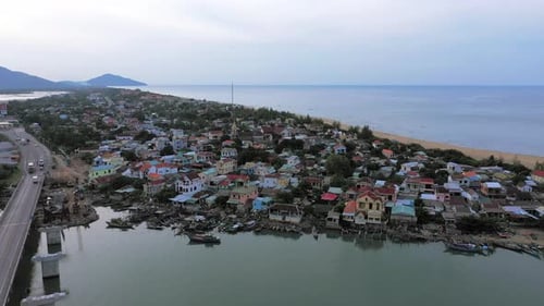 Drone, village and houses with ocean, bridge and landscape or architecture background for travel