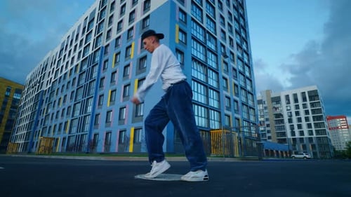 Active Pastime On City Street Of Youth In Evening Young Talented Man Dancing HipHop And Breakdance