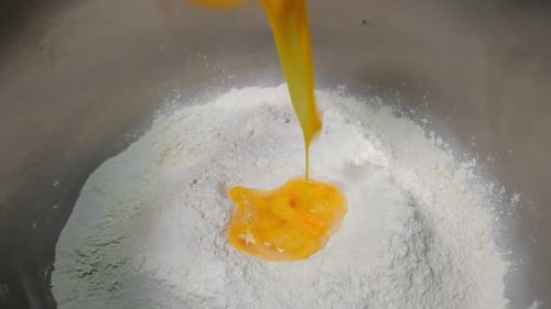 Adding Eggs to the Dough Kneading the Dough Industrial Production of Dough at the Factory