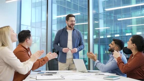 Colleagues Clapping for Man Presenting in Modern Office