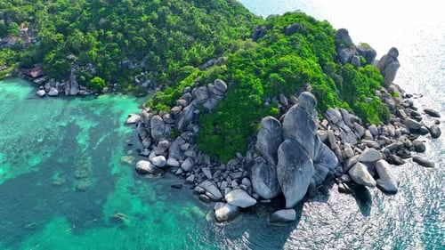 Rocky coastline with green forests and unique blue turquoise sea water.