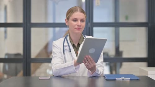 Doctor Working on Tablet in Office Setting