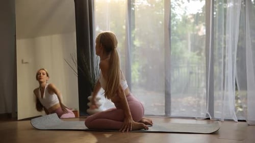 Woman Stretching on Yoga Mat in Bright Home