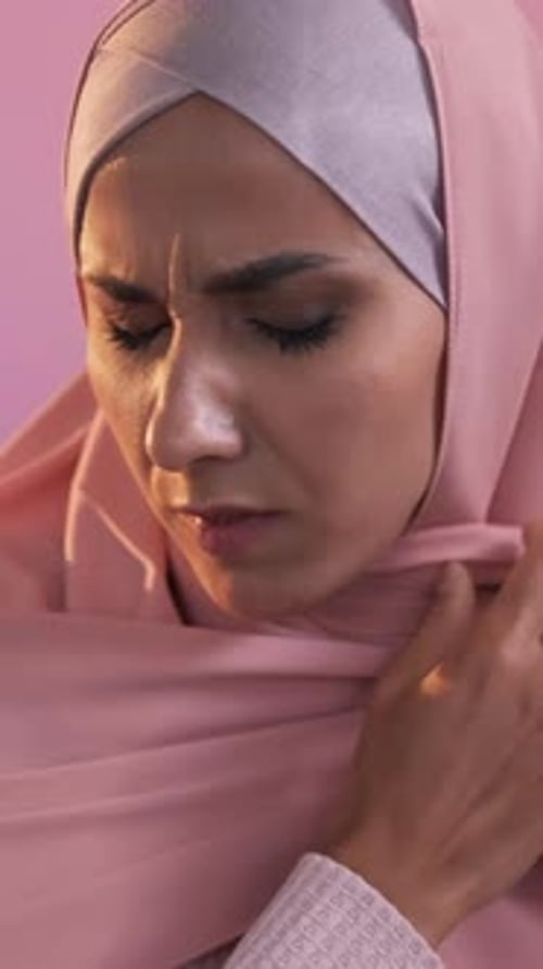 Woman in Headscarf Shows Discomfort Close Up