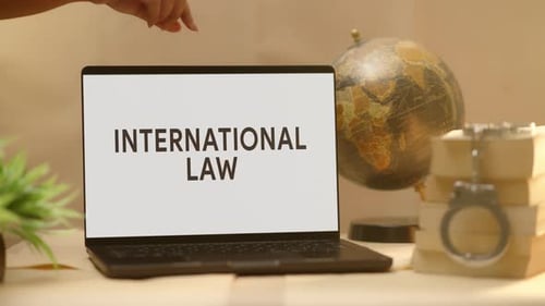 International Law Shown on Laptop Screen Near Globe