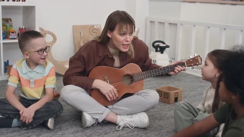 Woman Playing Ukulele and Singing With Children