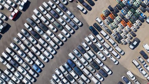 Aerial view of new cars in a massive parking lot