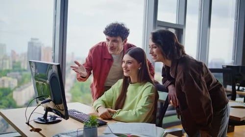 Smiling colleagues video call at office workstation