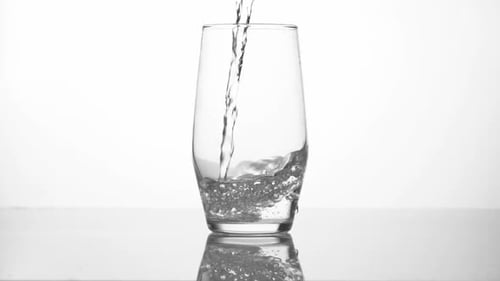 Water is Poured Into a Clear Glass