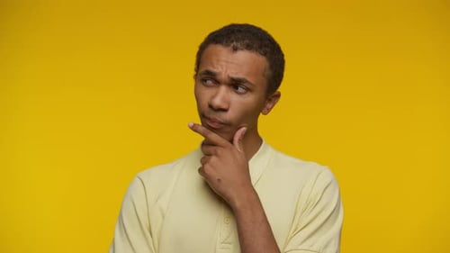 Thoughtful Young Adult Thinking Carefully in Studio Setting