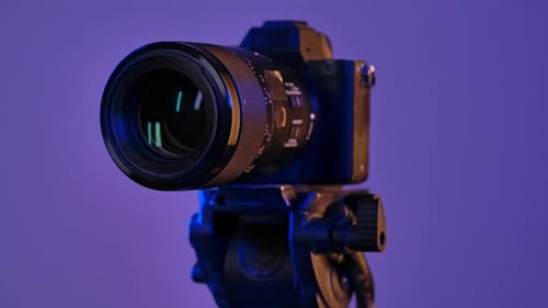 Camera on Tripod in Studio with Purple Lighting