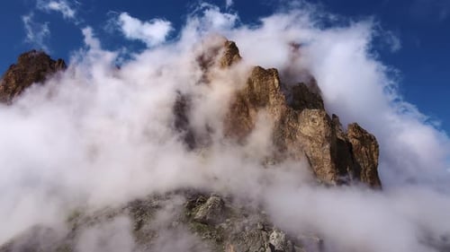 Mountain Ranges are Shrouded in White Air Clouds on a Sunny Day