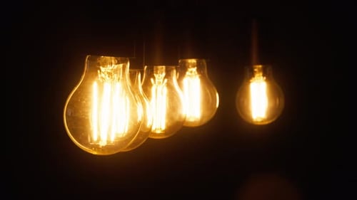 Closeup of the Turning on and Off of the Light Bulbs in the Room