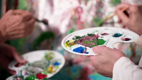 Close Up of Two People Painting Together