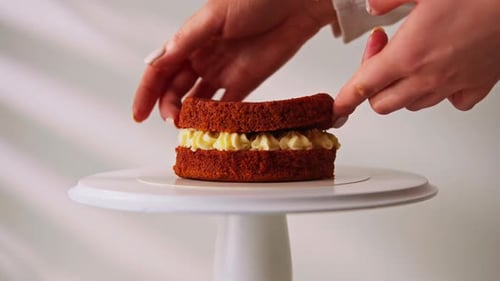 Hands Assemble Two-Layer Red Velvet Cake