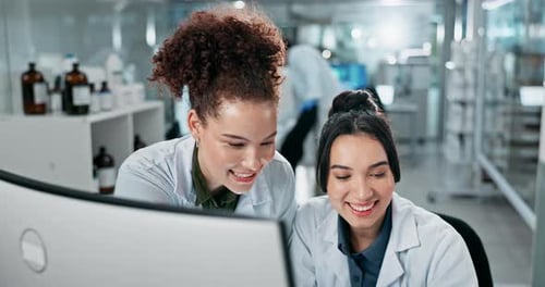 Scientists Collaborating on Computer in Modern Lab