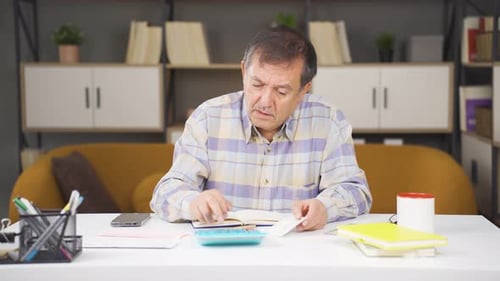 Senior Man Managing Finances at Home