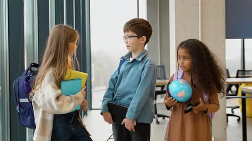 Elementary Students Chatting in School Hallway