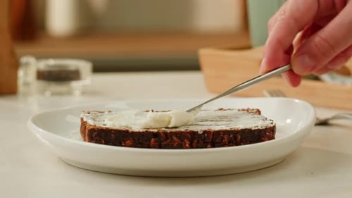 Cream Cheese Spread on Bread Slice in Kitchen