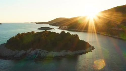 Golden sunset sunbeams over a scenic island on the Croatian Adriatic coast