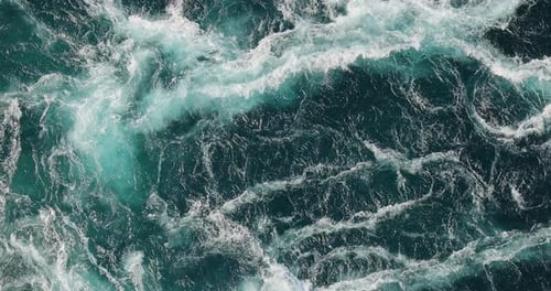 Blue waves of water of the river and the sea meet each other during high tide and low tide.