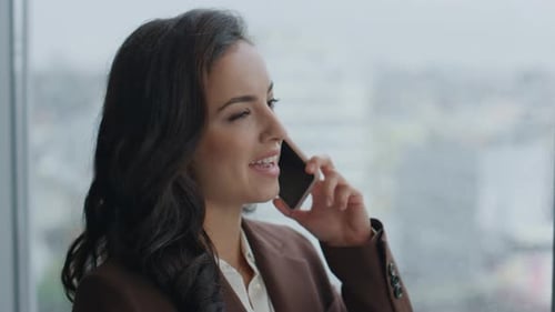 Smiling Businesswoman Chatting on Phone in Office