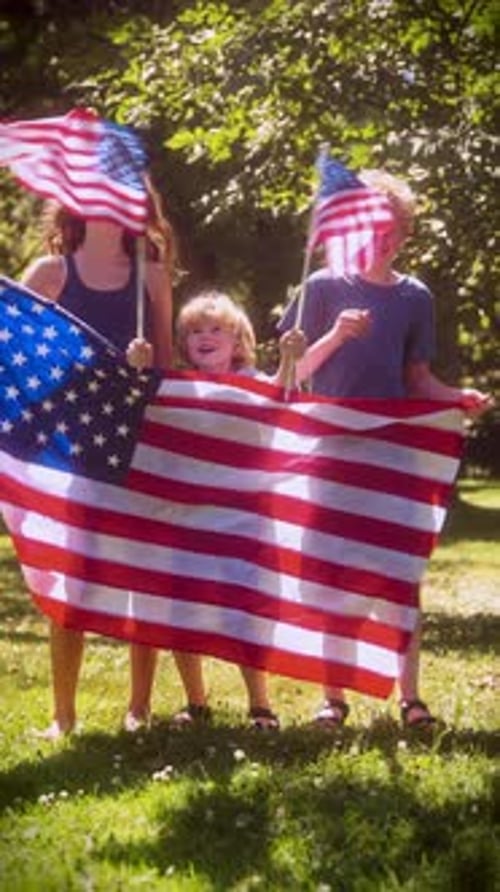 Smiling Children Waving American Flags in the Sun