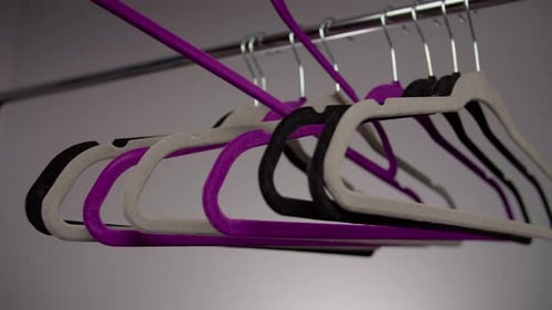 Colorful Clothes Hangers on Rack being Removed