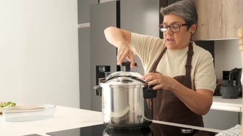 Woman Securing Lid on Stainless Steel Pressure Cooker