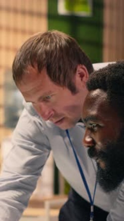 Vertical Video Diverse Corporate Office Scene with Team Collaboration Around Laptop