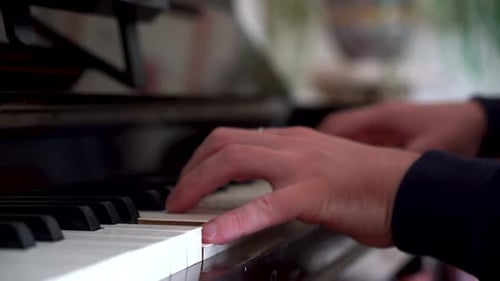 Male Pianist playing on a beautifully rustic old piano, student playing piano with close up keys. Cl