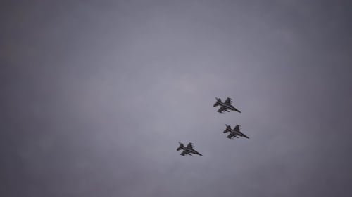 Three Fighter Jets Flying in Formation in a Cloudy Sky