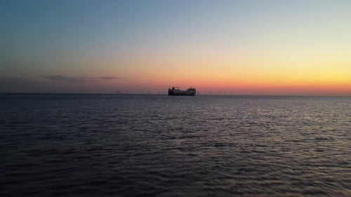 Aerial drone vew of cargo boat near port of Liverpool Great Britain at sunset
