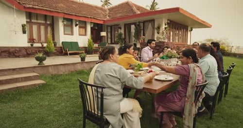 Family Meal Together Outside a Rural Home