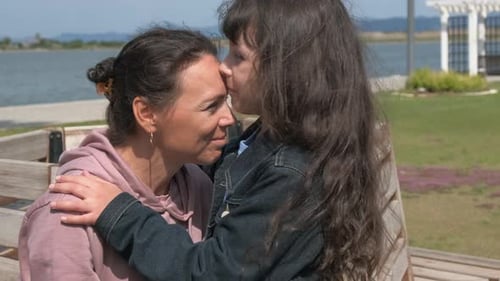 Mother and Daughter Share Sweet Hug in the Park