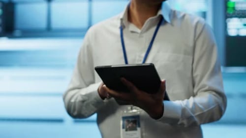 Adult Using Tablet in High-Tech Server Room