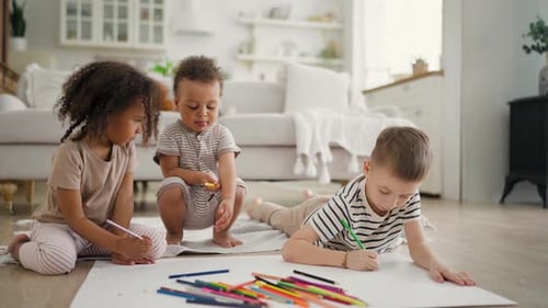 Children Drawing Together at Home with Colored Pencils