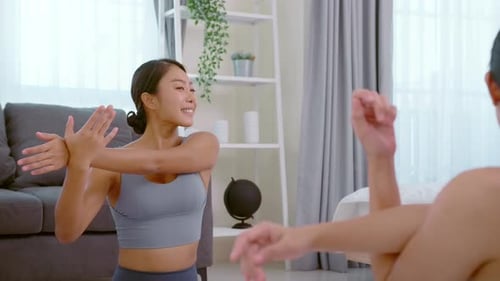 Friends Exercising and Stretching in Living Room
