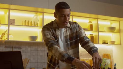 Man Preparing Food in Bright Kitchen at Home