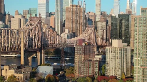 Aerial view of the Queensboro Bridge with the Manhattan skyline in the background.