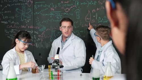 Students Doing Science Experiment with Teacher in Lab
